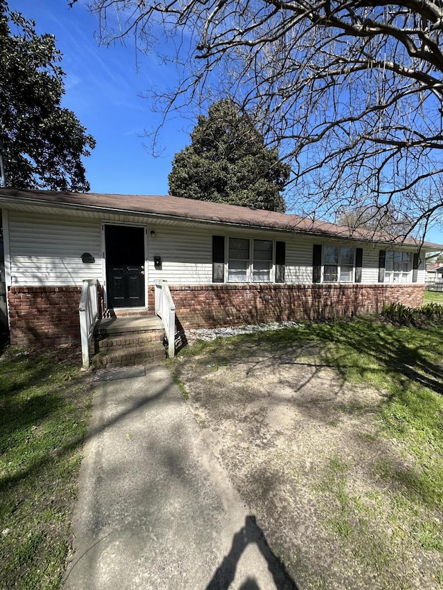 ranch-style house with a front lawn