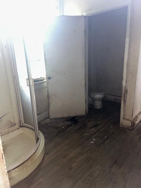 1620 12th St, Augusta, GA 30901 - bathroom featuring wood finished floors, toilet, and a stall shower
