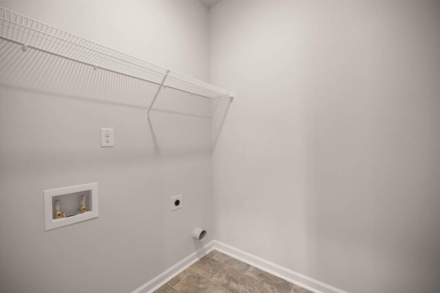 clothes washing area with laundry area, hookup for a washing machine, hookup for an electric dryer, and baseboards