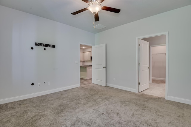 1056 Candleberry Dr, Grovetown, GA 30813 - unfurnished bedroom featuring light carpet, a spacious closet, and ceiling fan