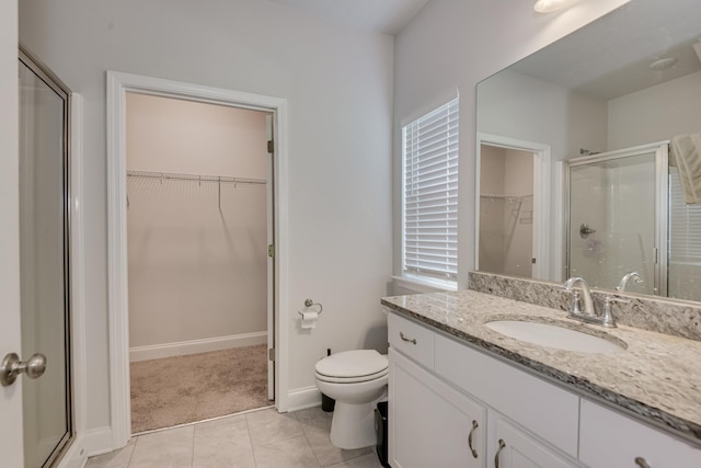 1056 Candleberry Dr, Grovetown, GA 30813 - bathroom featuring a walk in closet, a shower stall, vanity, and tile patterned floors