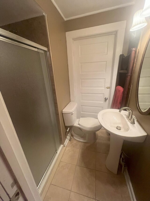 bathroom with tile patterned floors, sink, toilet, and walk in shower