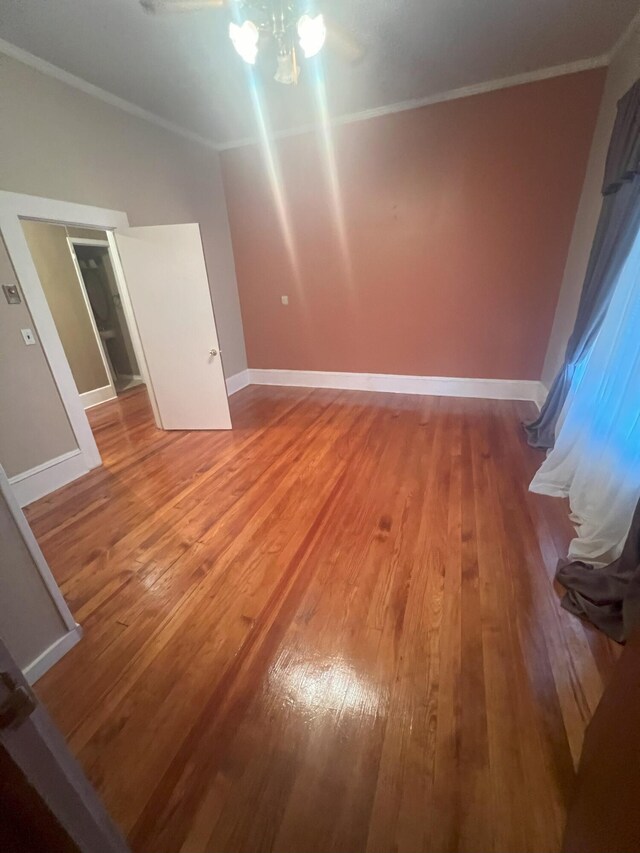 empty room featuring hardwood / wood-style floors and ornamental molding