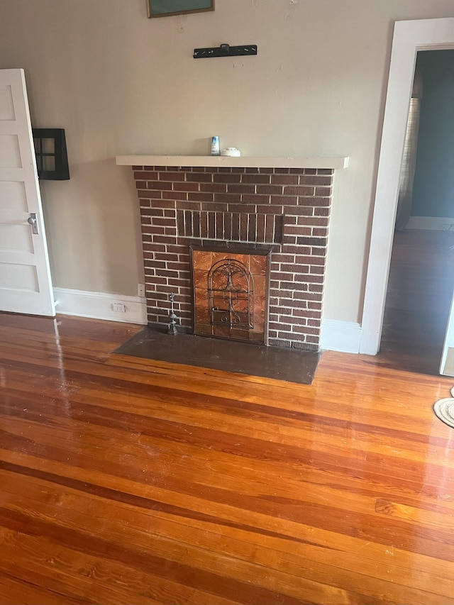 interior details with a fireplace and wood-type flooring