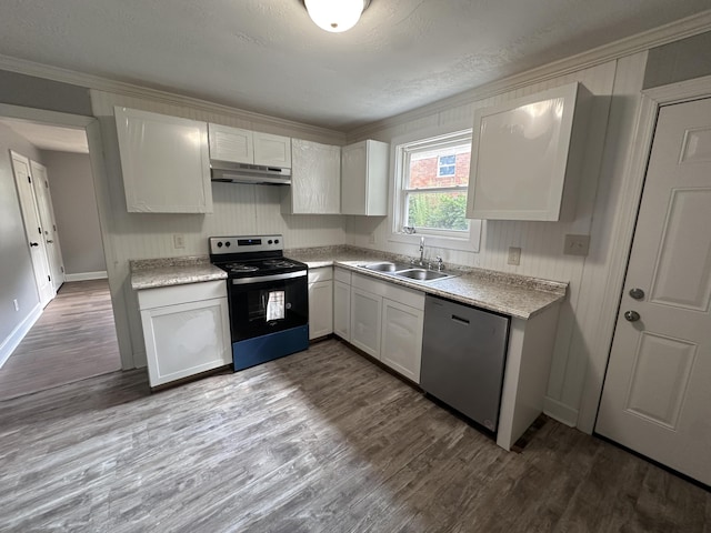 kitchen featuring hardwood / wood-style flooring, sink, white cabinetry, and stainless steel appliances