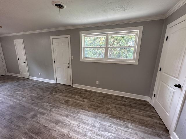 unfurnished room with dark wood-type flooring and ornamental molding