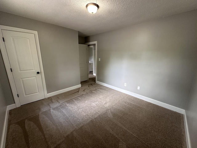 unfurnished bedroom featuring carpet flooring, a closet, and a textured ceiling