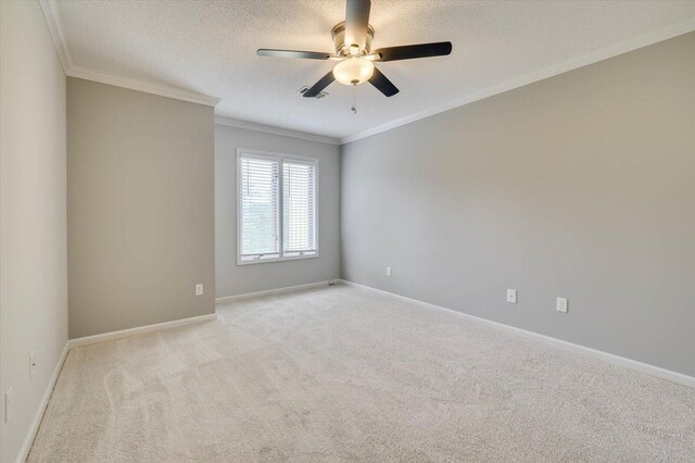 carpeted empty room with ceiling fan, a textured ceiling, and ornamental molding