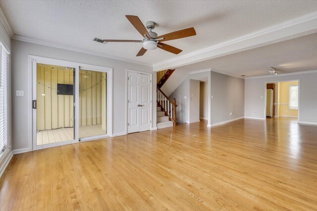 spare room featuring crown molding, light hardwood / wood-style flooring, ceiling fan, and a textured ceiling