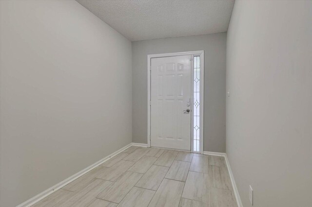 entryway featuring a textured ceiling