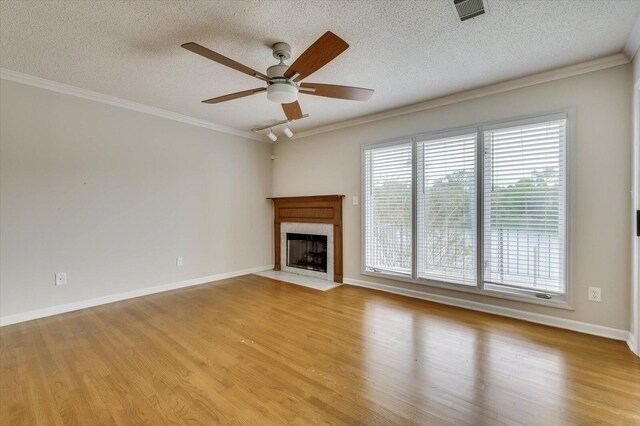 unfurnished living room featuring a textured ceiling, light wood-type flooring, ceiling fan, and crown molding