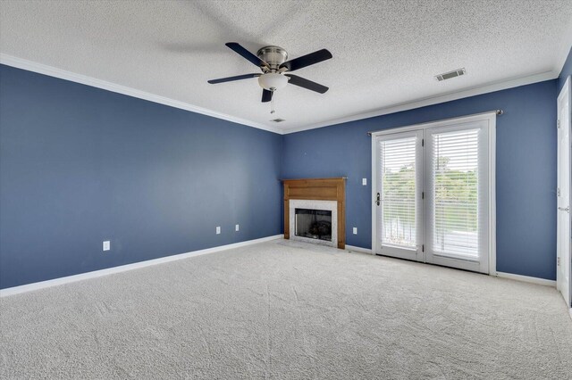 unfurnished living room with a textured ceiling, ceiling fan, carpet floors, and ornamental molding