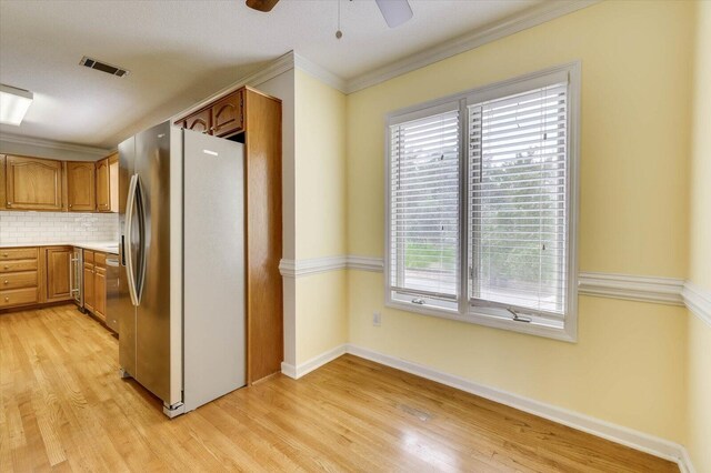 kitchen with decorative backsplash, stainless steel fridge with ice dispenser, light hardwood / wood-style floors, and ornamental molding