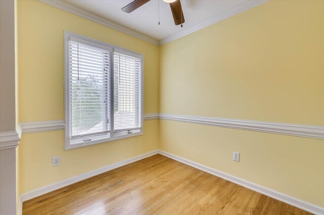 spare room with light hardwood / wood-style floors, ceiling fan, and crown molding