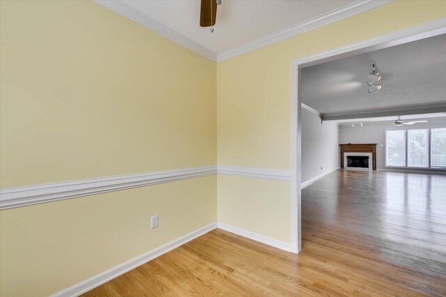 unfurnished room with ceiling fan, wood-type flooring, and ornamental molding