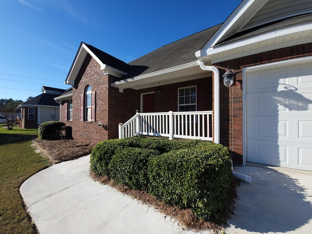 view of home's exterior featuring a porch and a garage