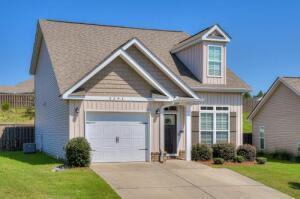 view of front of house featuring driveway, an attached garage, board and batten siding, and a front yard