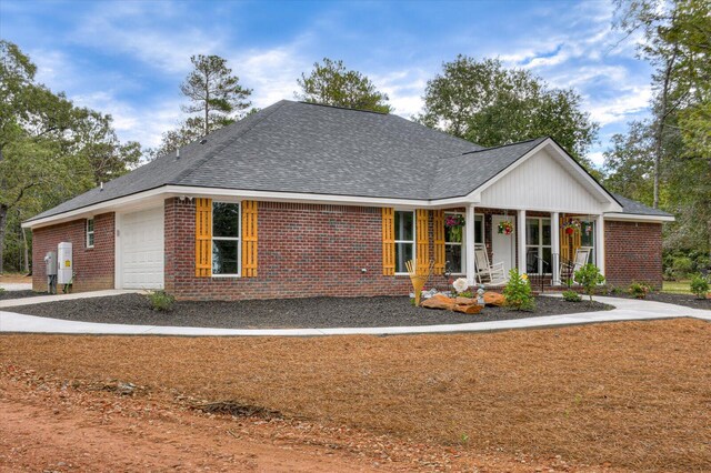 view of front of property featuring a porch and a garage