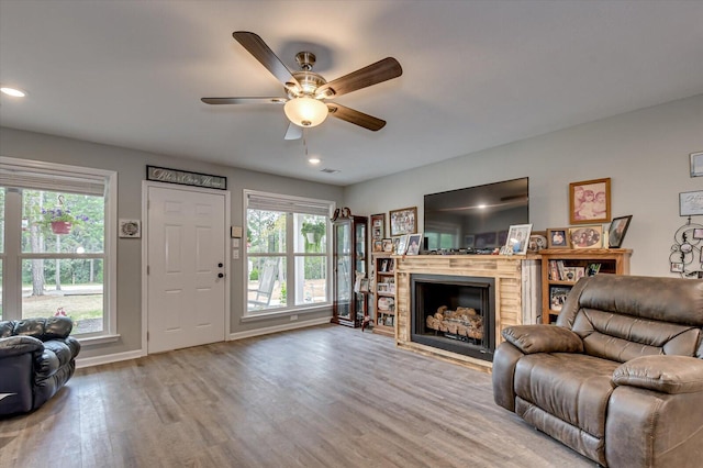 living room with wood-type flooring, plenty of natural light, and ceiling fan