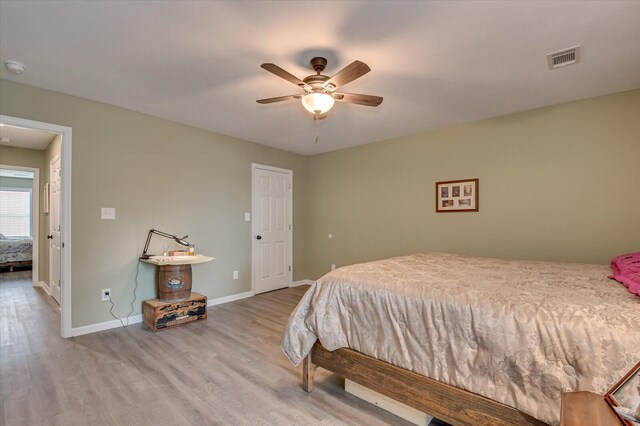 bedroom with hardwood / wood-style flooring and ceiling fan