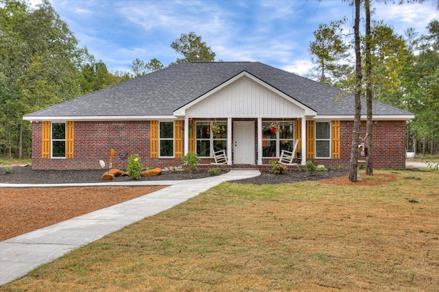 single story home featuring a front lawn and a porch