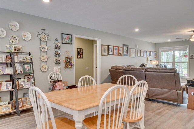 dining space featuring ceiling fan and light wood-type flooring