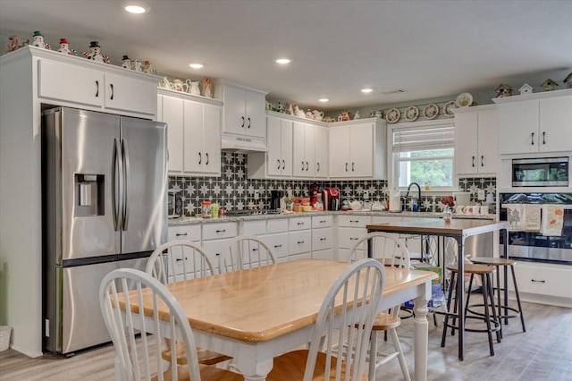 kitchen featuring white cabinets and appliances with stainless steel finishes