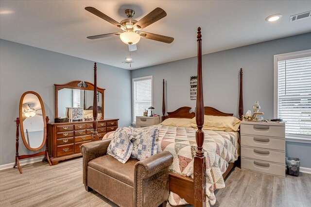 bedroom with ceiling fan and light hardwood / wood-style floors