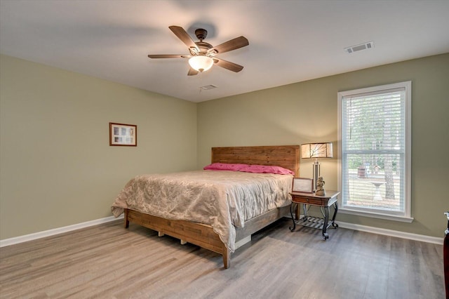 bedroom with ceiling fan and hardwood / wood-style flooring