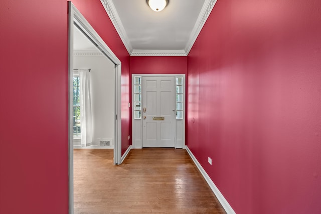 entrance foyer featuring ornamental molding and wood-type flooring