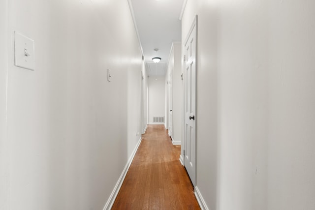 corridor with hardwood / wood-style floors