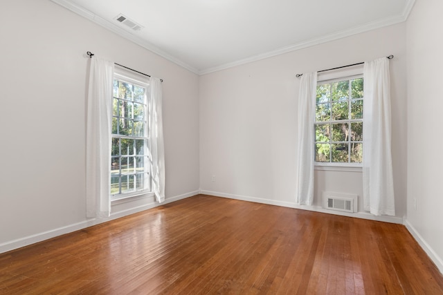 unfurnished room with hardwood / wood-style floors, crown molding, and plenty of natural light