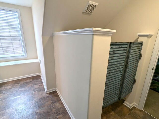 interior space with stone finish flooring, visible vents, and baseboards