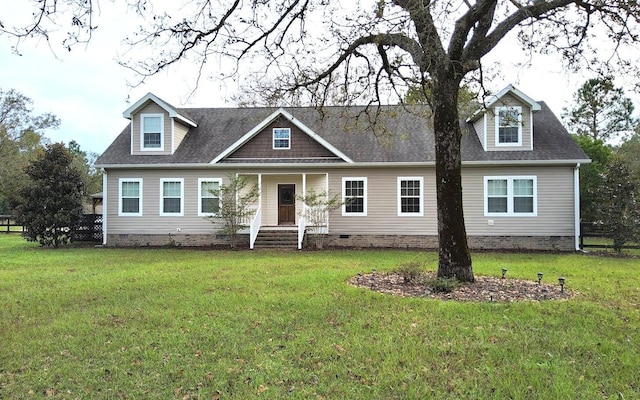 cape cod-style house with crawl space, a shingled roof, and a front lawn