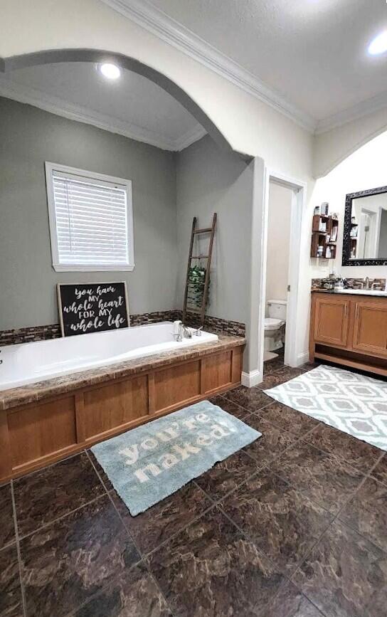 bathroom with toilet, recessed lighting, vanity, a bath, and crown molding