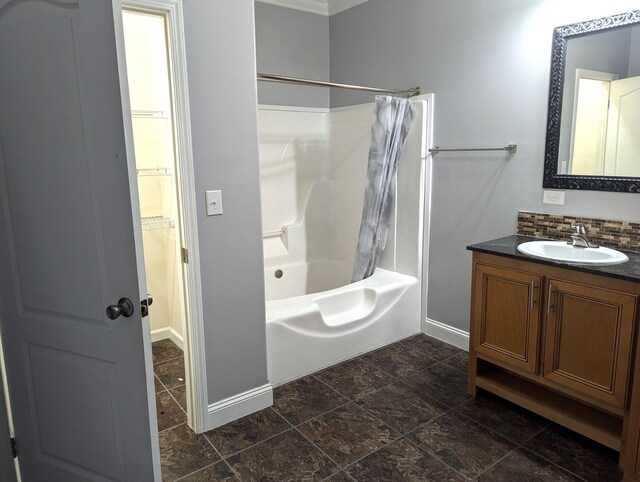 bathroom featuring shower / bath combo, baseboards, decorative backsplash, and vanity