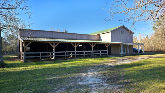 exterior space with metal roof, an outdoor structure, and an exterior structure