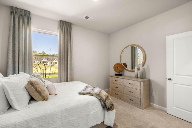 bedroom with light colored carpet