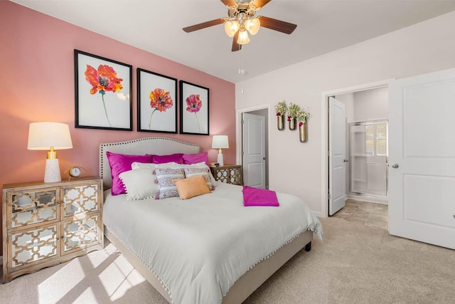 carpeted bedroom with ensuite bathroom and ceiling fan