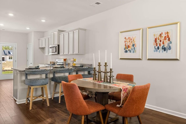 dining room with dark hardwood / wood-style flooring