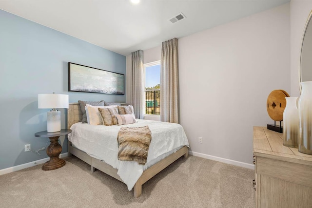 bedroom featuring light colored carpet