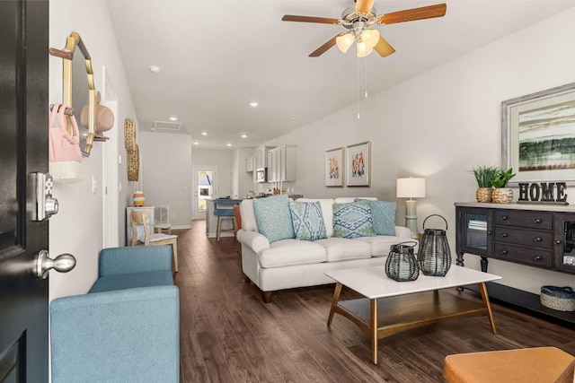 living room with ceiling fan and dark hardwood / wood-style flooring