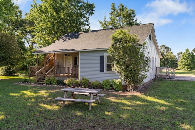 5950 E Ga Highway 24, Louisville, GA 30434 - back of house featuring roof with shingles, a yard, a ceiling fan, and stairs