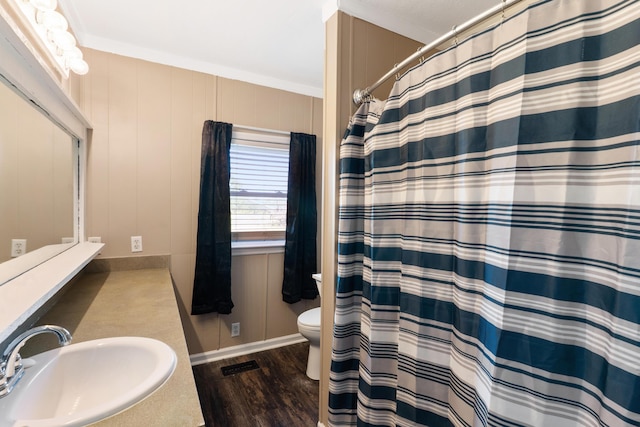 5950 E Ga Highway 24, Louisville, GA 30434 - full bathroom with a sink, toilet, wood finished floors, a shower with shower curtain, and ornamental molding