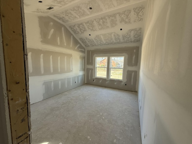 empty room with lofted ceiling