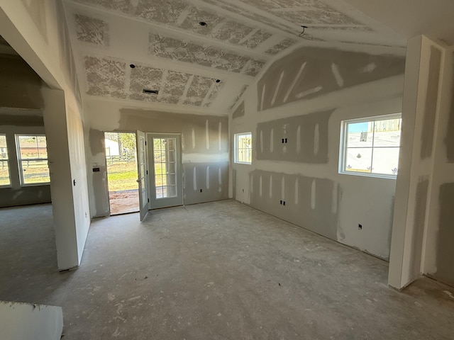 empty room featuring vaulted ceiling and a healthy amount of sunlight