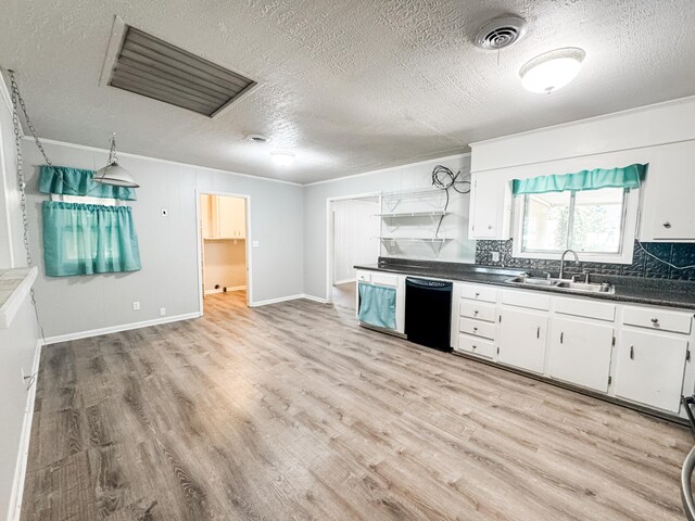 2255 Walden Dr, Augusta, GA 30904 - kitchen featuring dishwasher, a sink, dark countertops, a textured ceiling, and light wood-type flooring