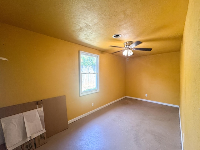 2255 Walden Dr, Augusta, GA 30904 - spare room featuring a ceiling fan, finished concrete flooring, a textured ceiling, and baseboards