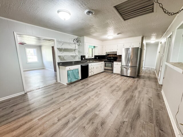 2255 Walden Dr, Augusta, GA 30904 - kitchen featuring appliances with stainless steel finishes, a sink, light wood-style floors, dark countertops, and open shelves