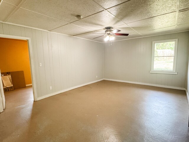 2255 Walden Dr, Augusta, GA 30904 - empty room featuring ceiling fan, concrete flooring, baseboards, a smoke detector, and wood walls